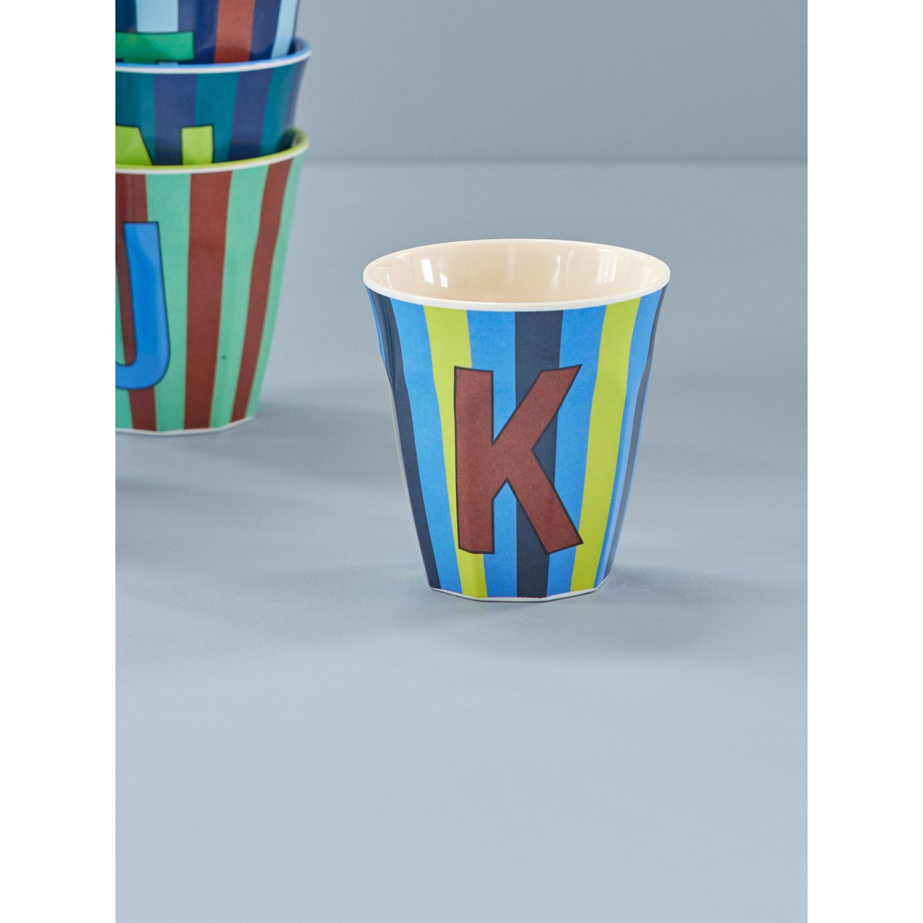 rice-dk-melamine-cup-with-the-letter-k-stripes-blueish-medium-250ml-rice-melcu-alpstrkb